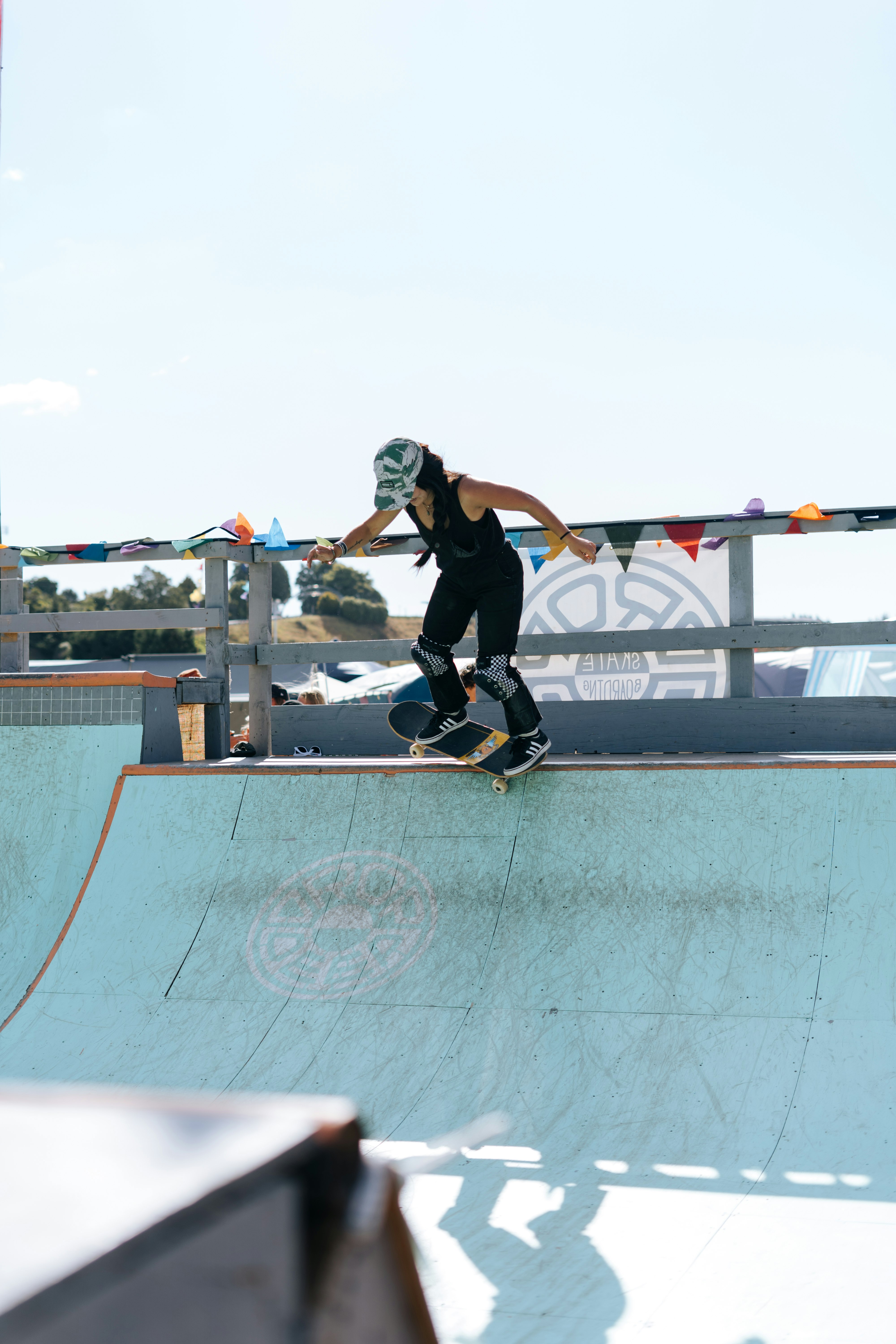 man in black tank top and black shorts doing skateboard stunts during daytime